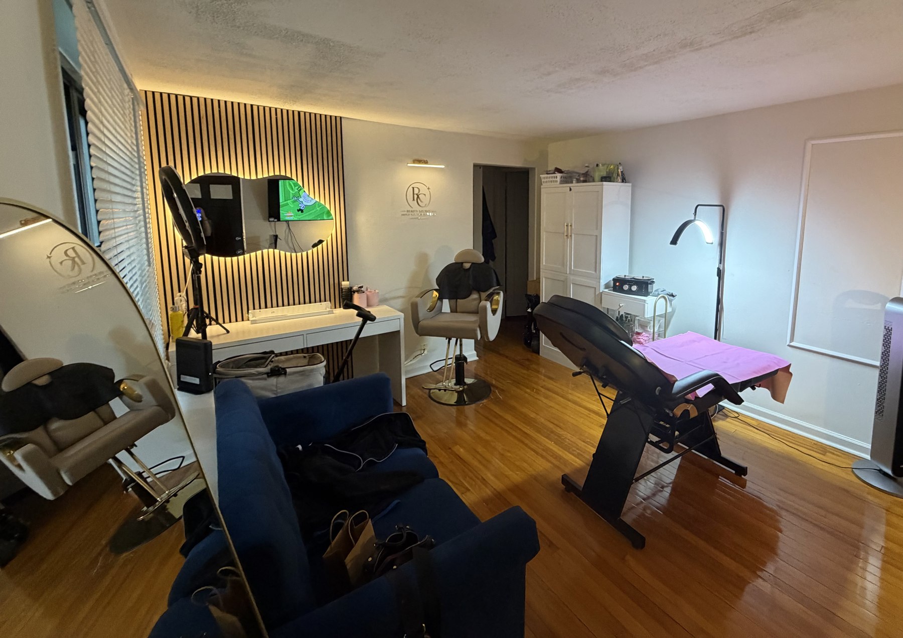 Inside Reca Beauty Lounge with treatment beds, mirrors and warm lighting