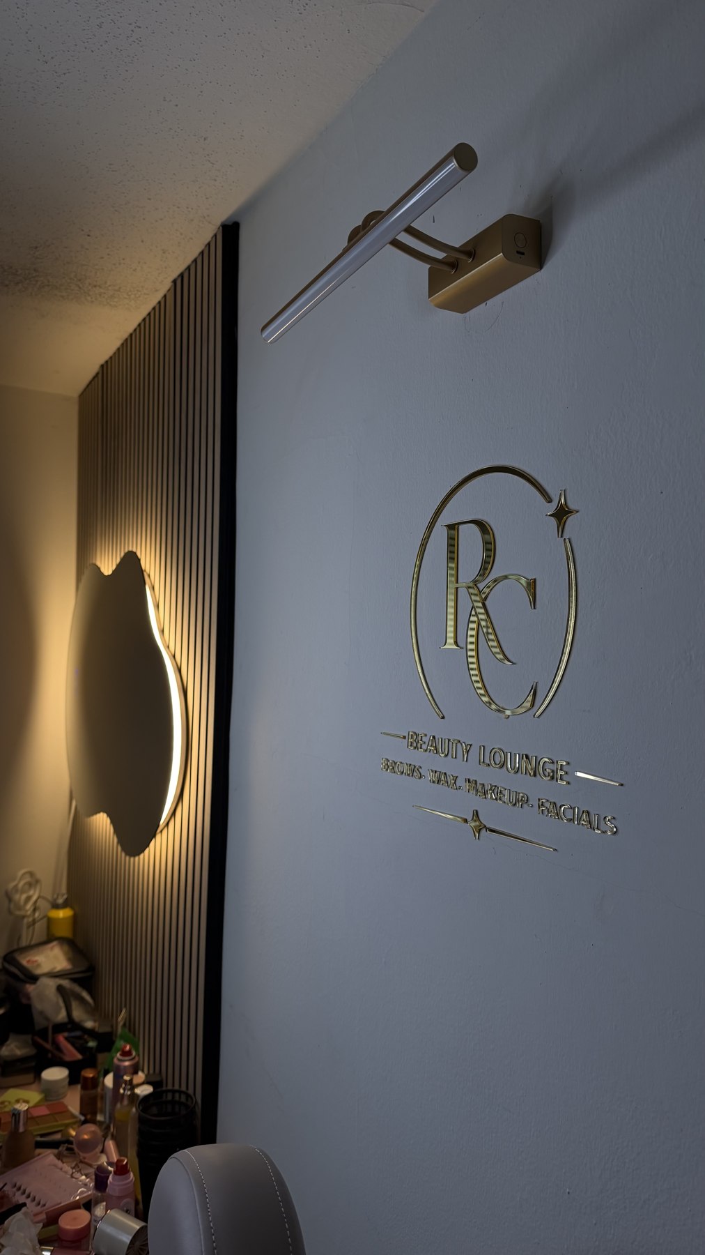 Gold Reca Beauty Lounge sign inside the studio