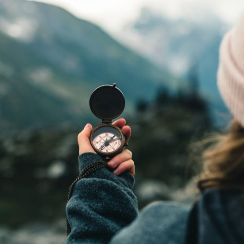 Woman holding a compass during a midlife transition and emotional life change