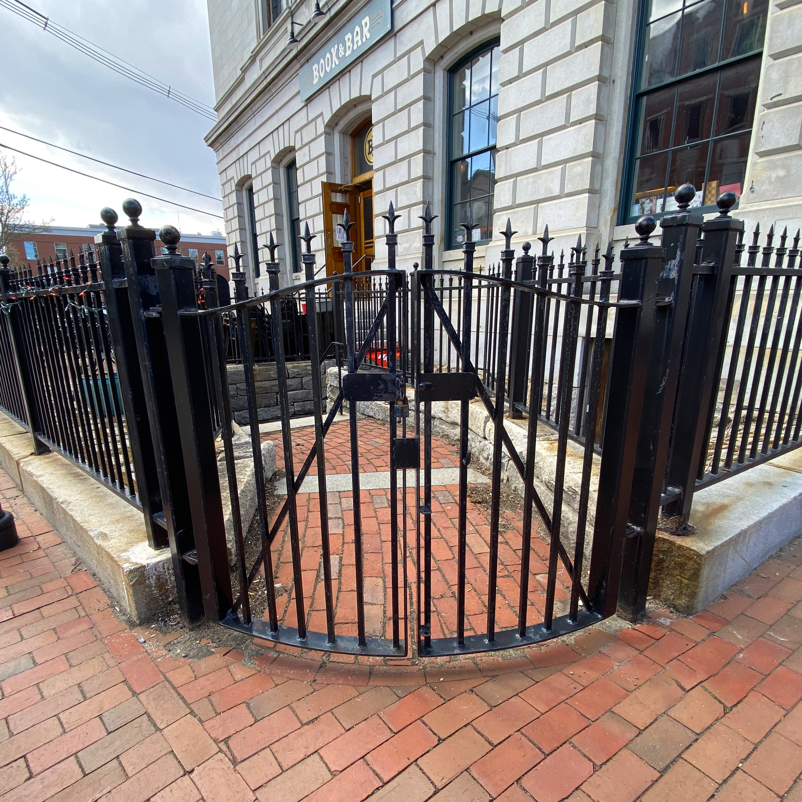 Curved iron gate at the top of the stairs to the entrance of Kimberly Sarah Photography in Portsmouth NH