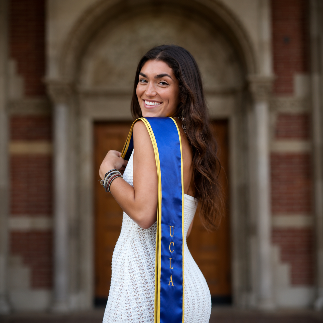 Zoe smiling in her UCLA graduation sash