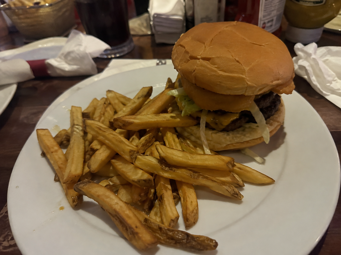 Unoptimized casual dining burger and fries photo before Everything AI optimization.