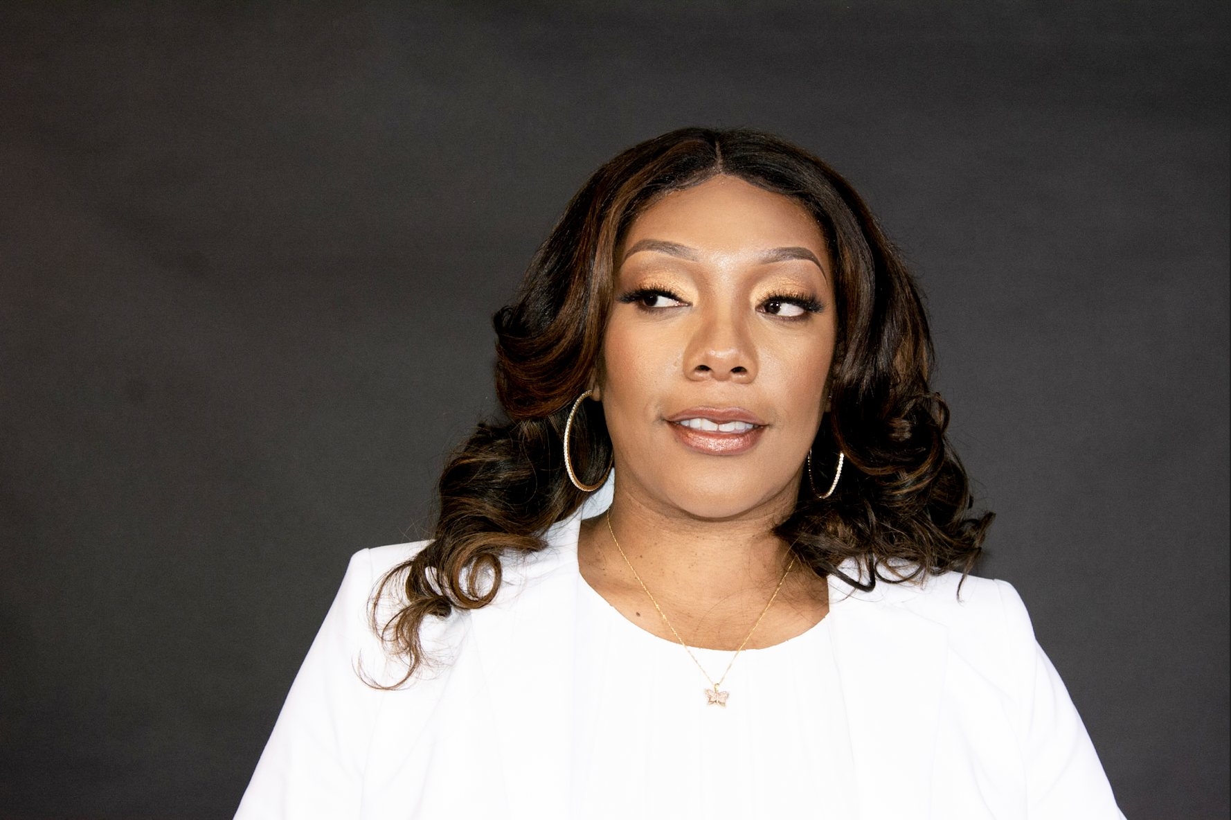 Dr. Eukeethia Barnes, author and business strategist, in a white blazer