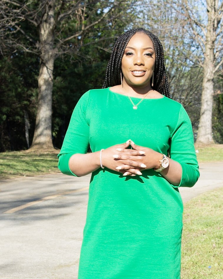 Dr. Eukeethia Barnes smiling outdoors in a green dress