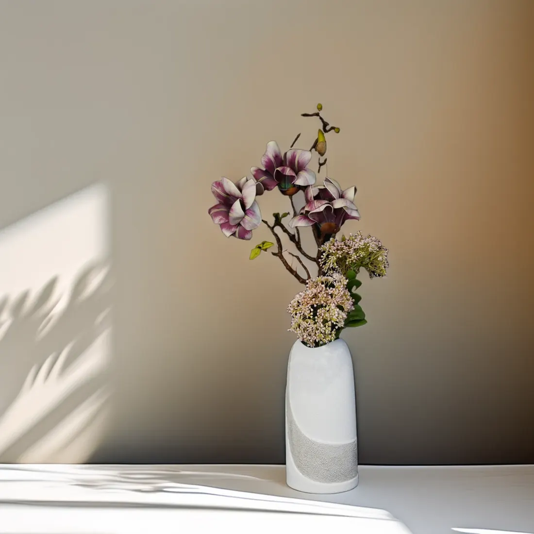 White Clytie A porcelain vase with an airy flower arrangement in warm afternoon light