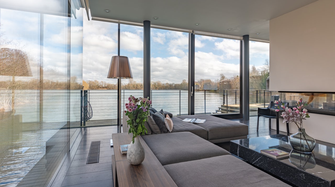 Interior panorama of the Glass House - floor-to-ceiling glazing with private lake view