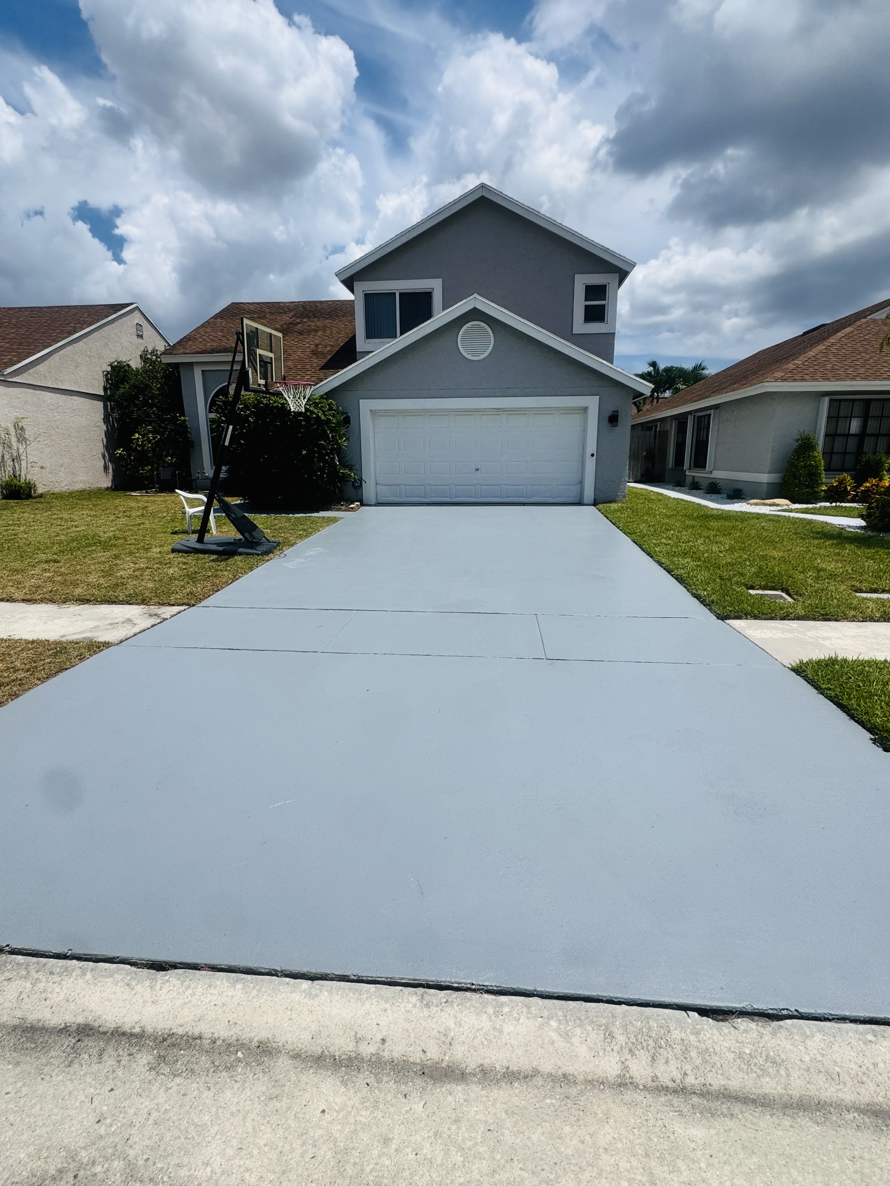 Concrete driveway stained grey and sealed in Parkland, FL