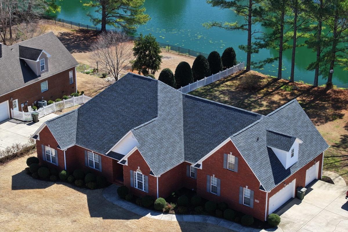 Completed architectural shingle roof replacement on a brick home