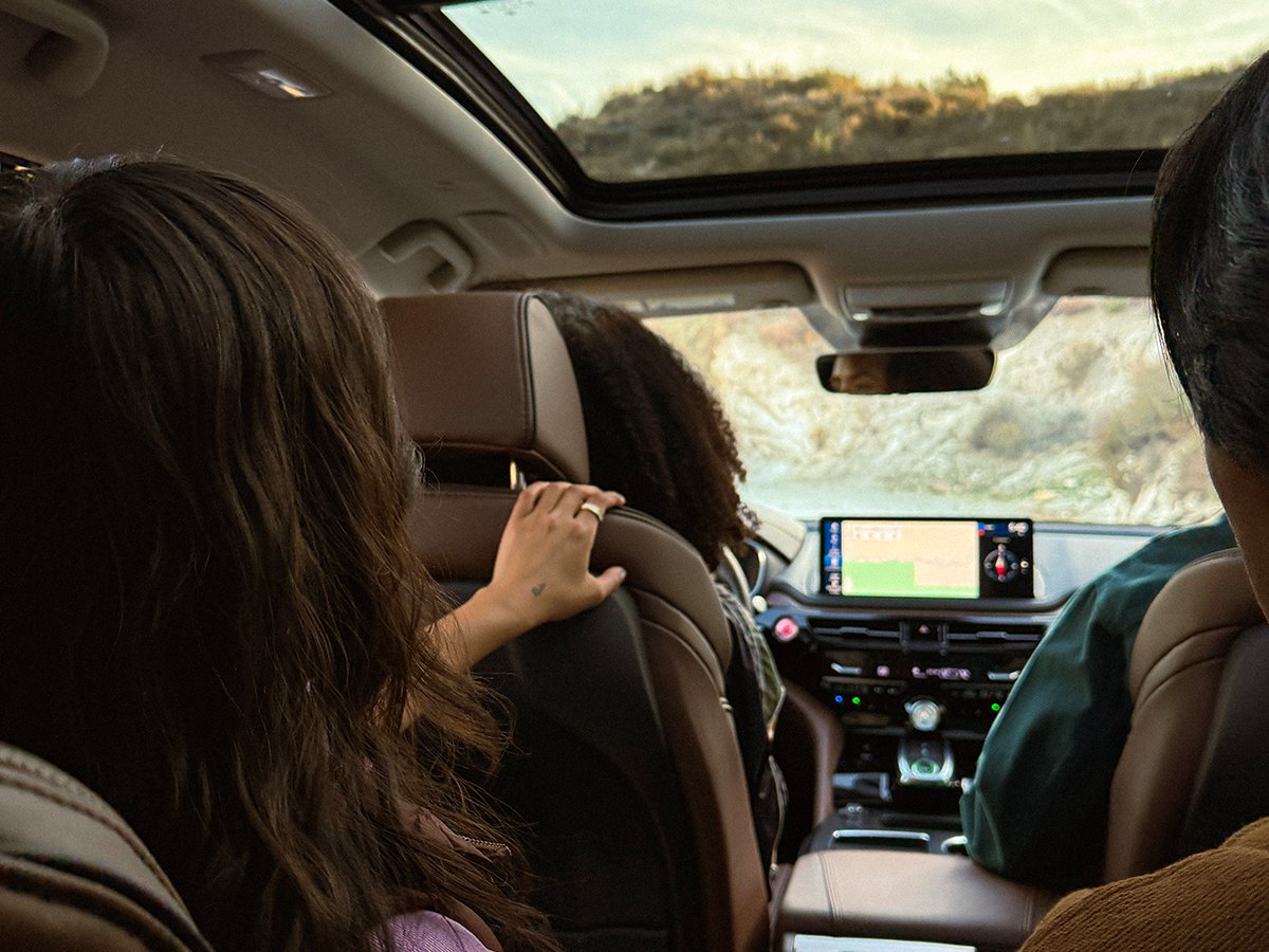 A family riding in a 2026 Acura MDX under the panoramic moonroof