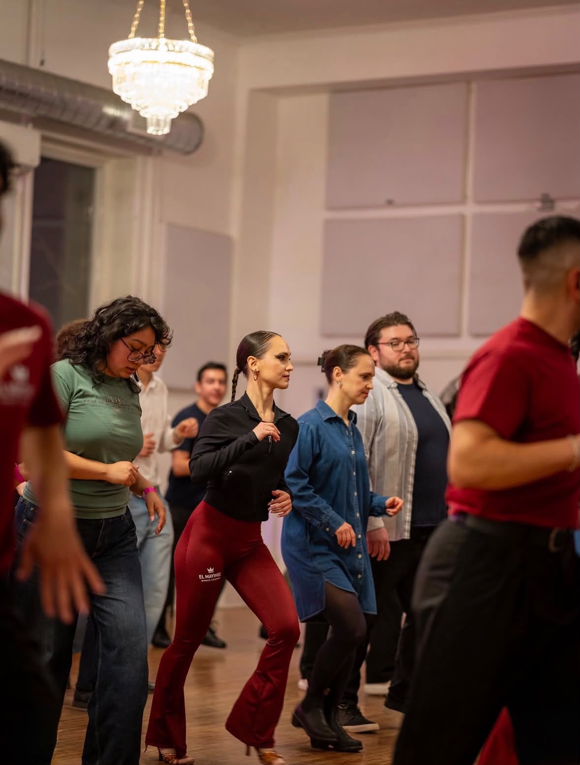 Beginners learning salsa in a class at El Mayimbe Dance Company in Toronto