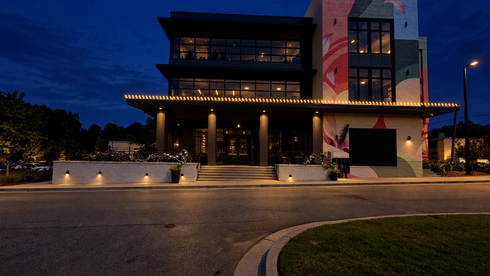 Commercial holiday mockup with warm white roofline lighting above a modern building entrance