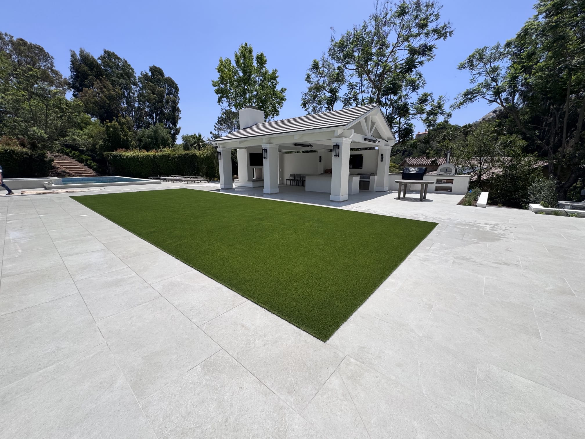 Large artificial turf area integrated with a modern patio pavilion