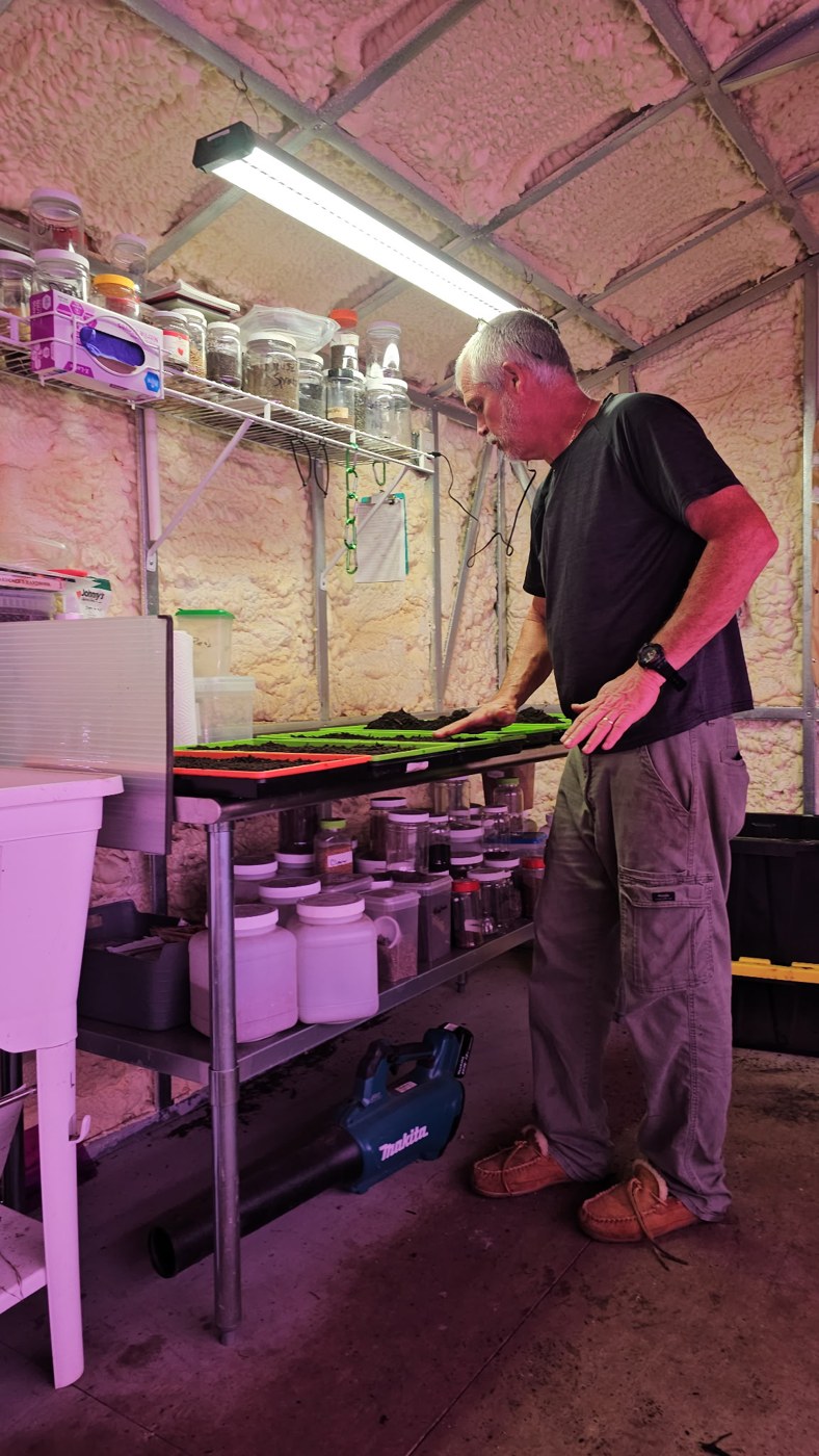 David Hall seeding trays at the workbench