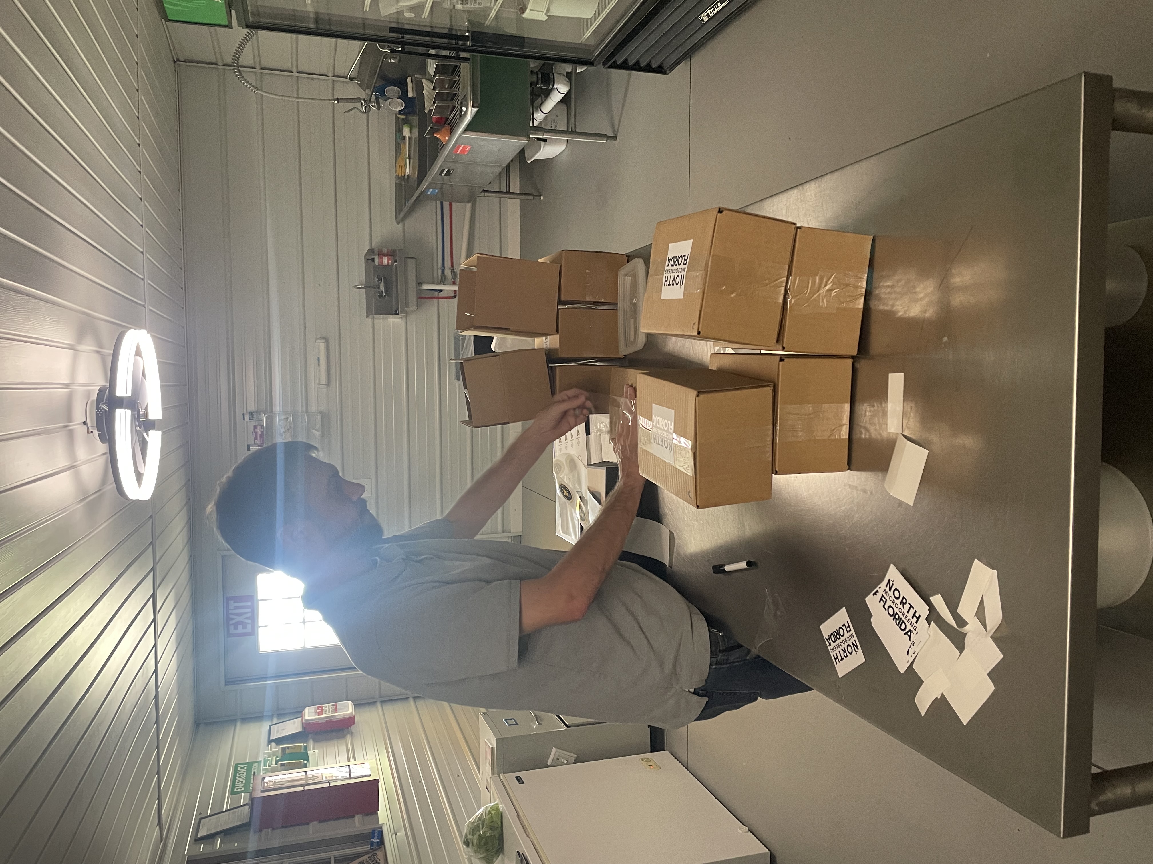 Trevor packing subscription boxes on the farm in Fort White, Florida