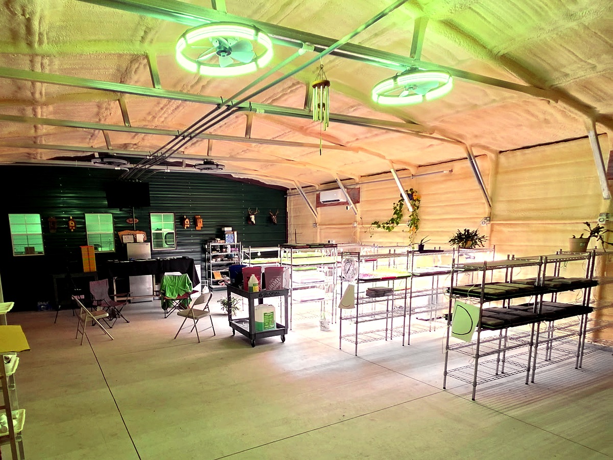 The full grow room at North Florida Microgreens, racks along one wall and open floor