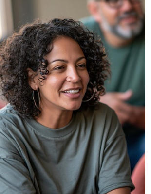 Woman speaking during a supportive group conversation about family conflict and communication Woman speaking during a supportive group conversation about family conflict and communication