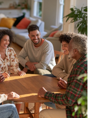Multi-generational family talking together at home, representing family counselling and improved communication Multi-generational family talking together at home, representing family counselling and improved communication