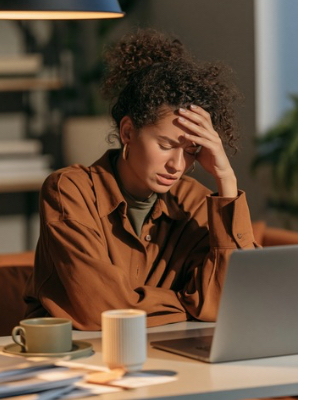     Overwhelmed woman struggling with low mood and emotional exhaustion while trying to work from home