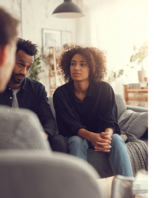 Couple discussing relationship challenges with a counsellor during their first couples counselling session Couple discussing relationship challenges with a counsellor during their first couples counselling session