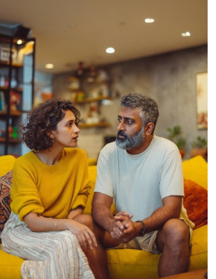 Couple having a difficult conversation at home before seeking couples counselling and relationship support Couple having a difficult conversation at home before seeking couples counselling and relationship support