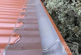 White corrugated roof gutter guard with garden