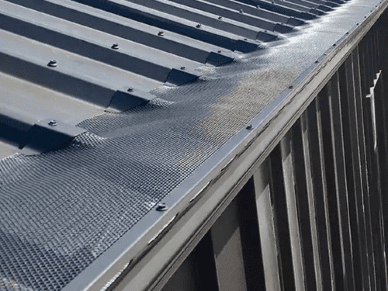 Gutter guard mesh on a pale corrugated roof