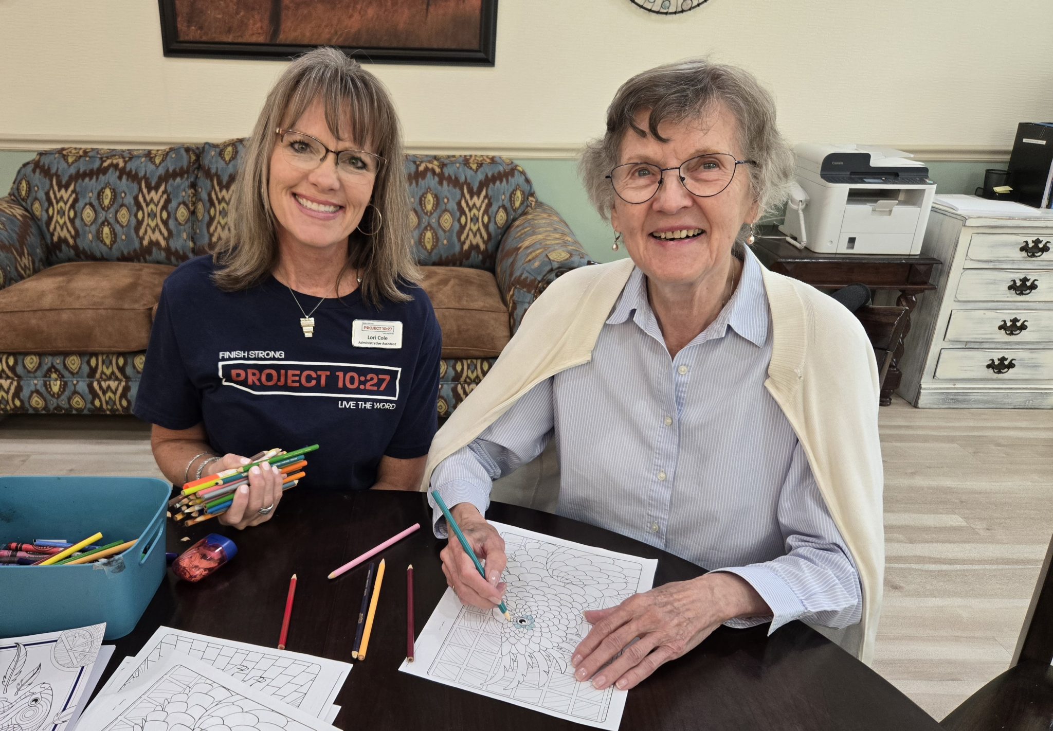 Volunteer smiling with a senior