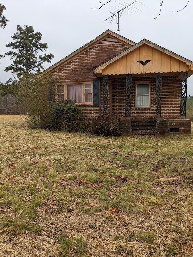 Vacant property with overgrown yard