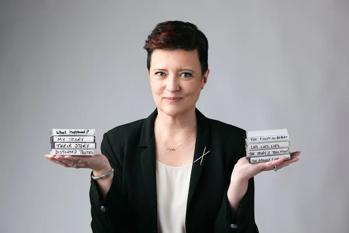 Vanessa Cardenas holding stacks representing different stories and unanswered questions after betrayal