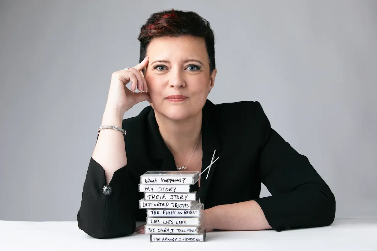 Vanessa Cardenas with stacked cassette tapes representing the stories and beliefs couples carry after betrayal