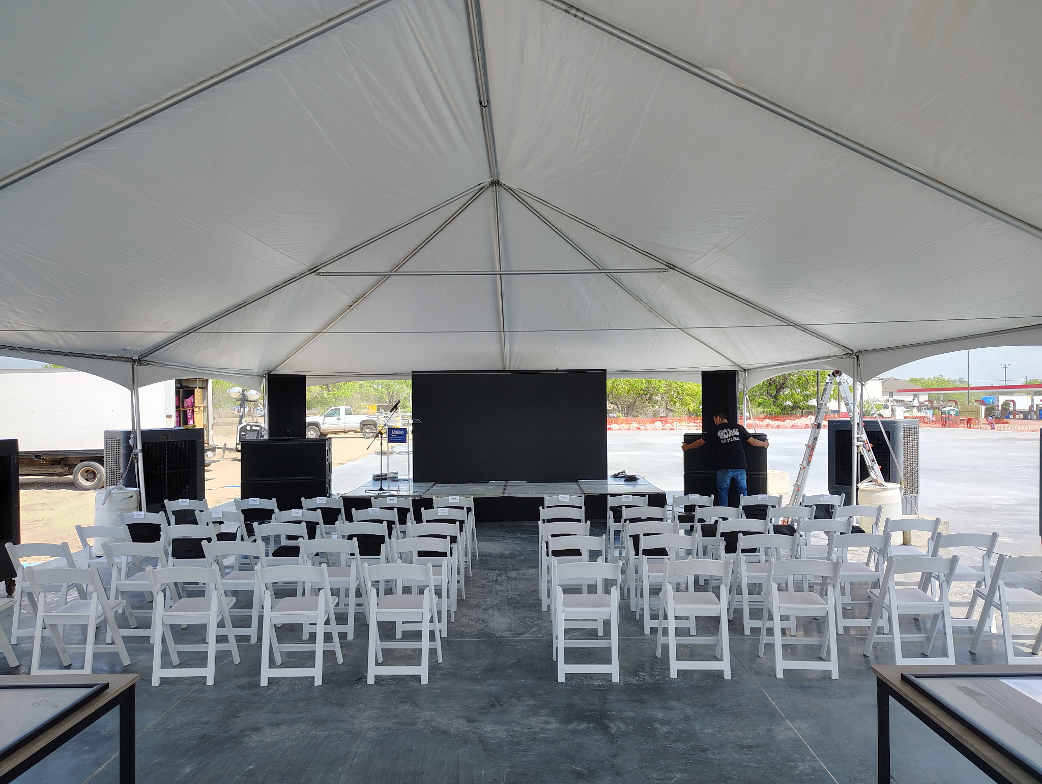 Elegant clear-top event tent with string lights at an evening reception