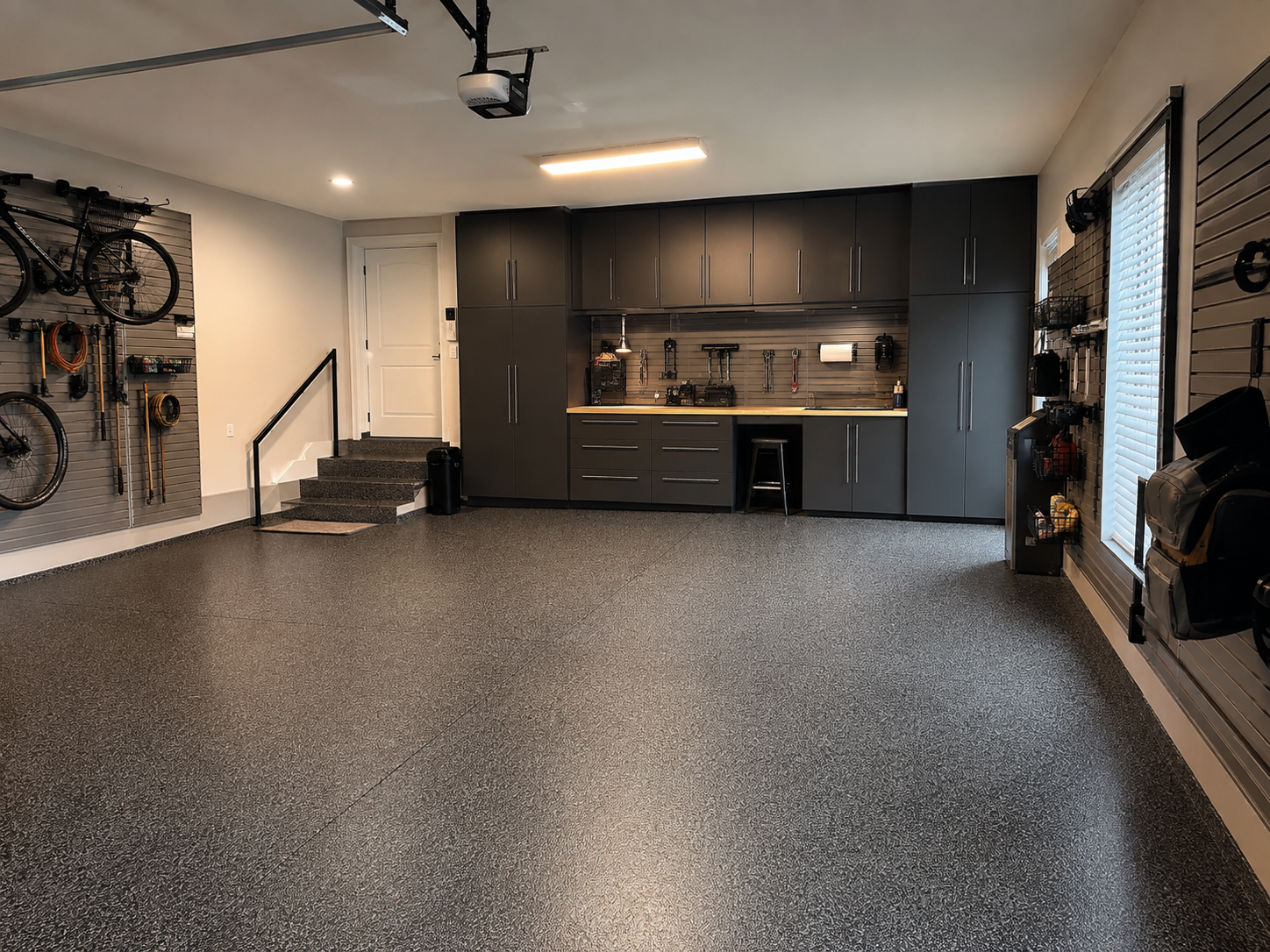 Dark garage cabinetry and resin flooring inspiration