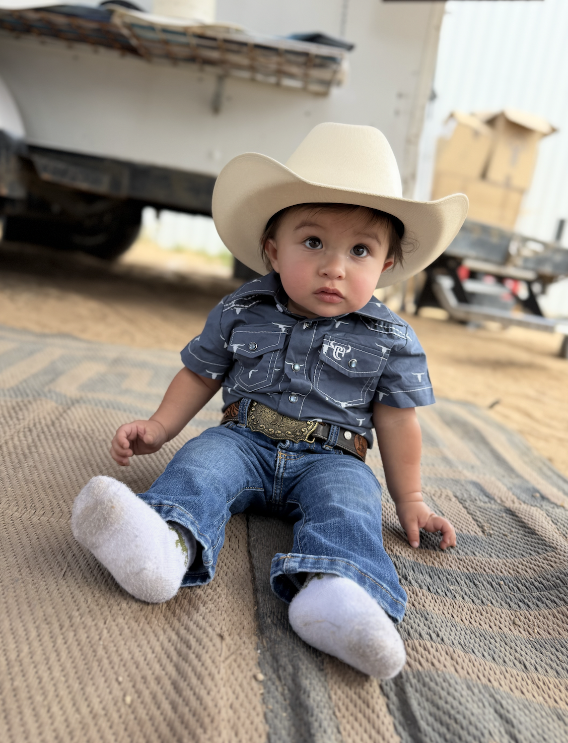 Little one in an L Cross hat