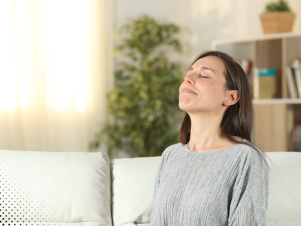 Woman breathing comfortably indoors during an indoor air quality inspection in a Delaware home.
