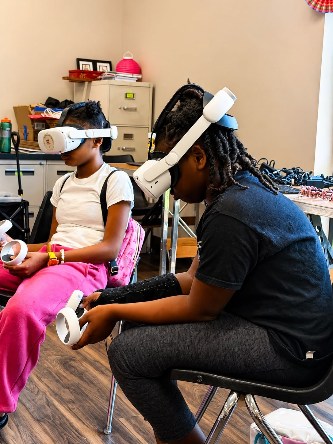 Two participants trying virtual reality headsets