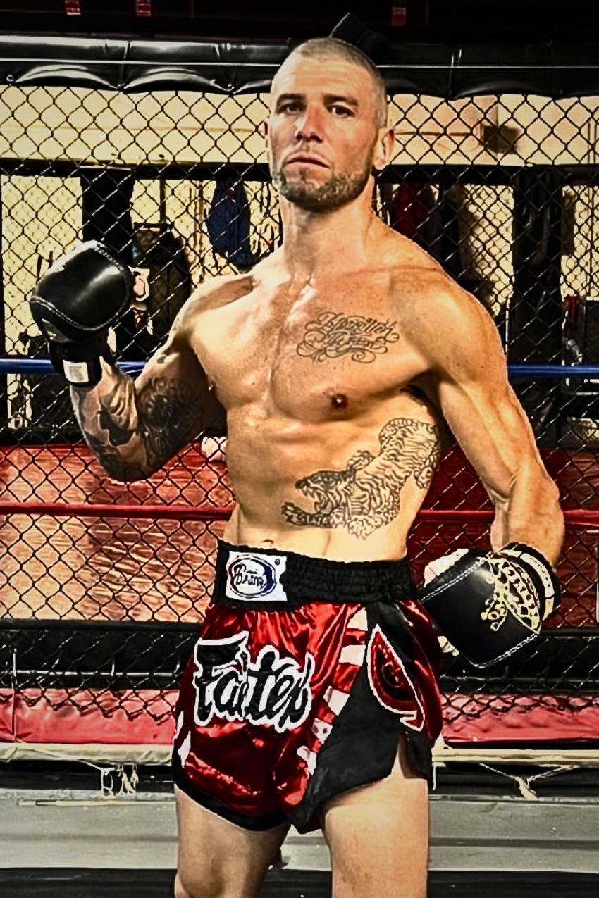 Mark Klemm, head coach of Baan Muay Thai South, in Muay Thai shorts and gloves at X-Zen Sports