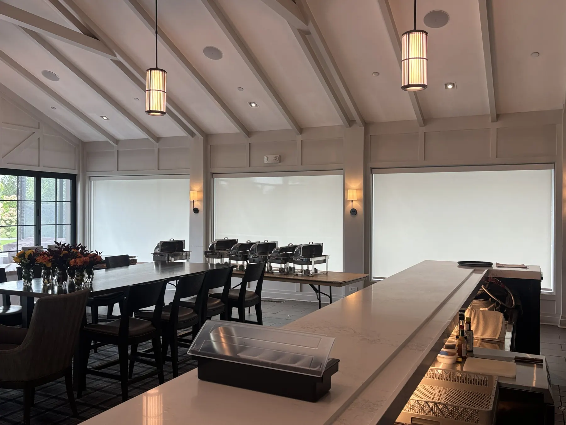 Roller shades in a vaulted clubhouse dining room