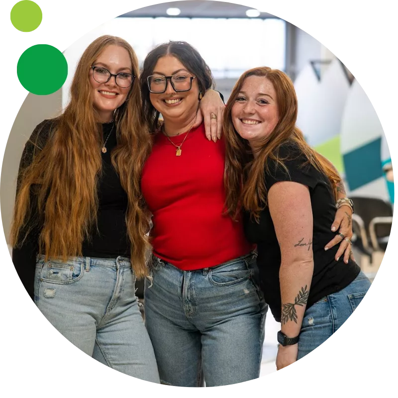 Three smiling stylists at Ten Sails Salons in Maryland, a locally owned Great Clips group