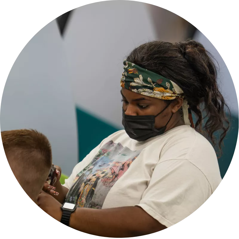 Cosmetologist cutting a client’s hair at Ten Sails Salons, a caring Great Clips team