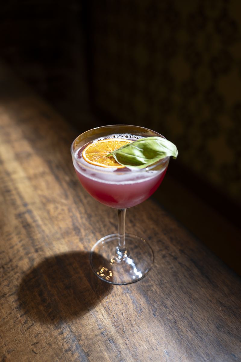 A red cocktail in window light