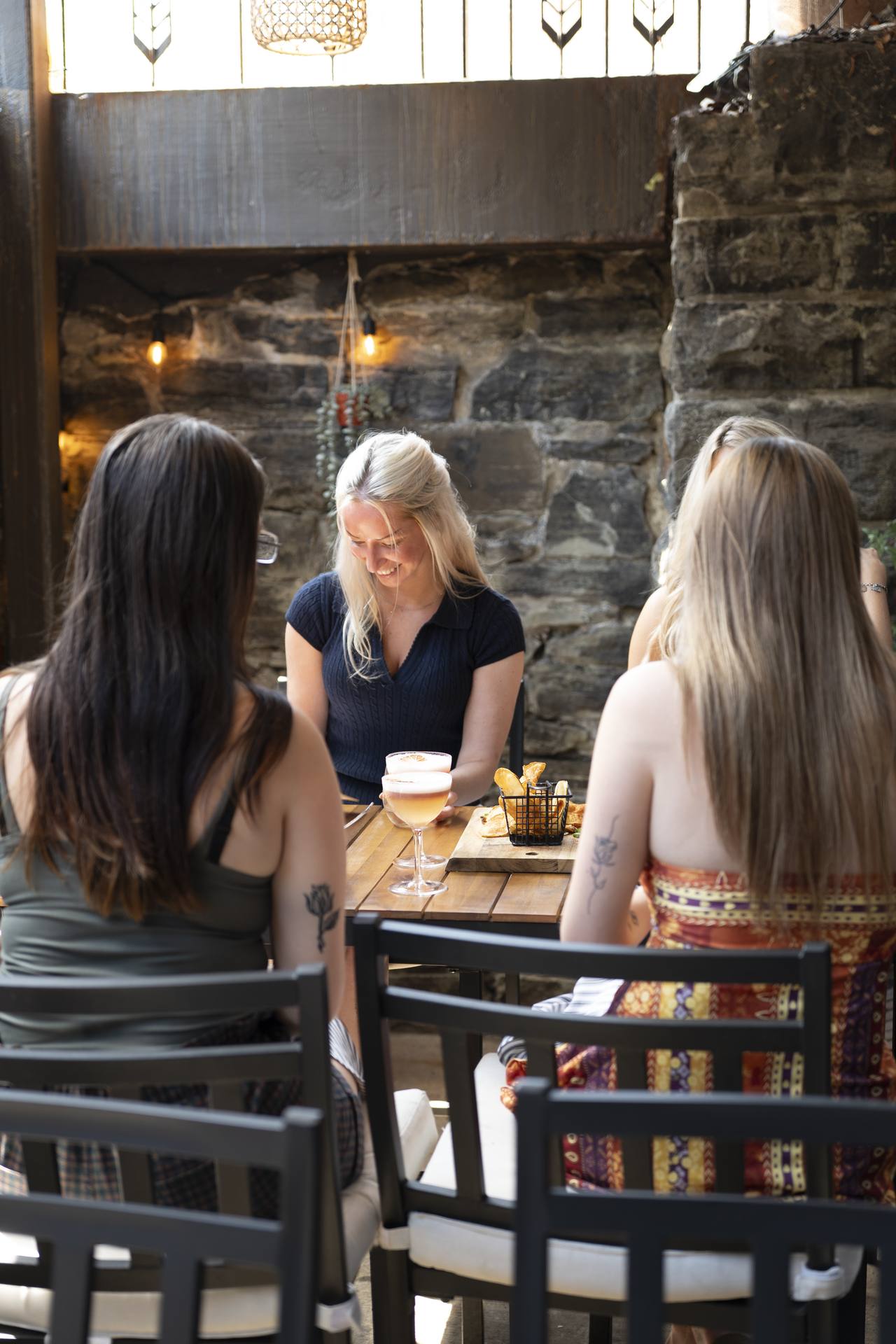 Friends at a patio table in Syracuse