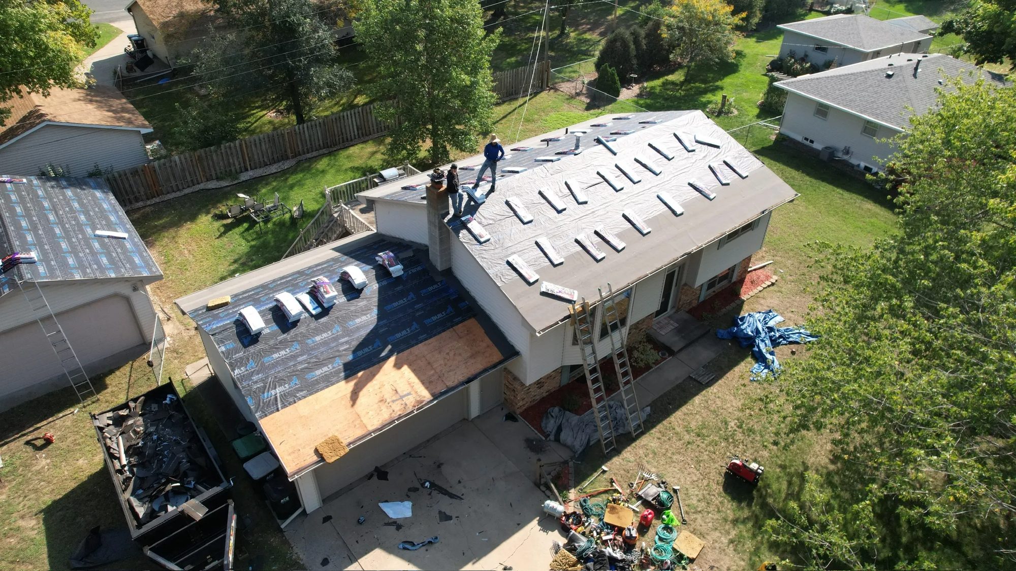 Aerial view of a Charter Home Renovation crew replacing a roof