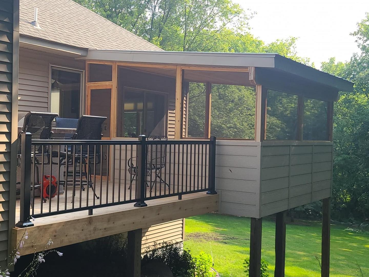 Covered deck with screened porch and black railing