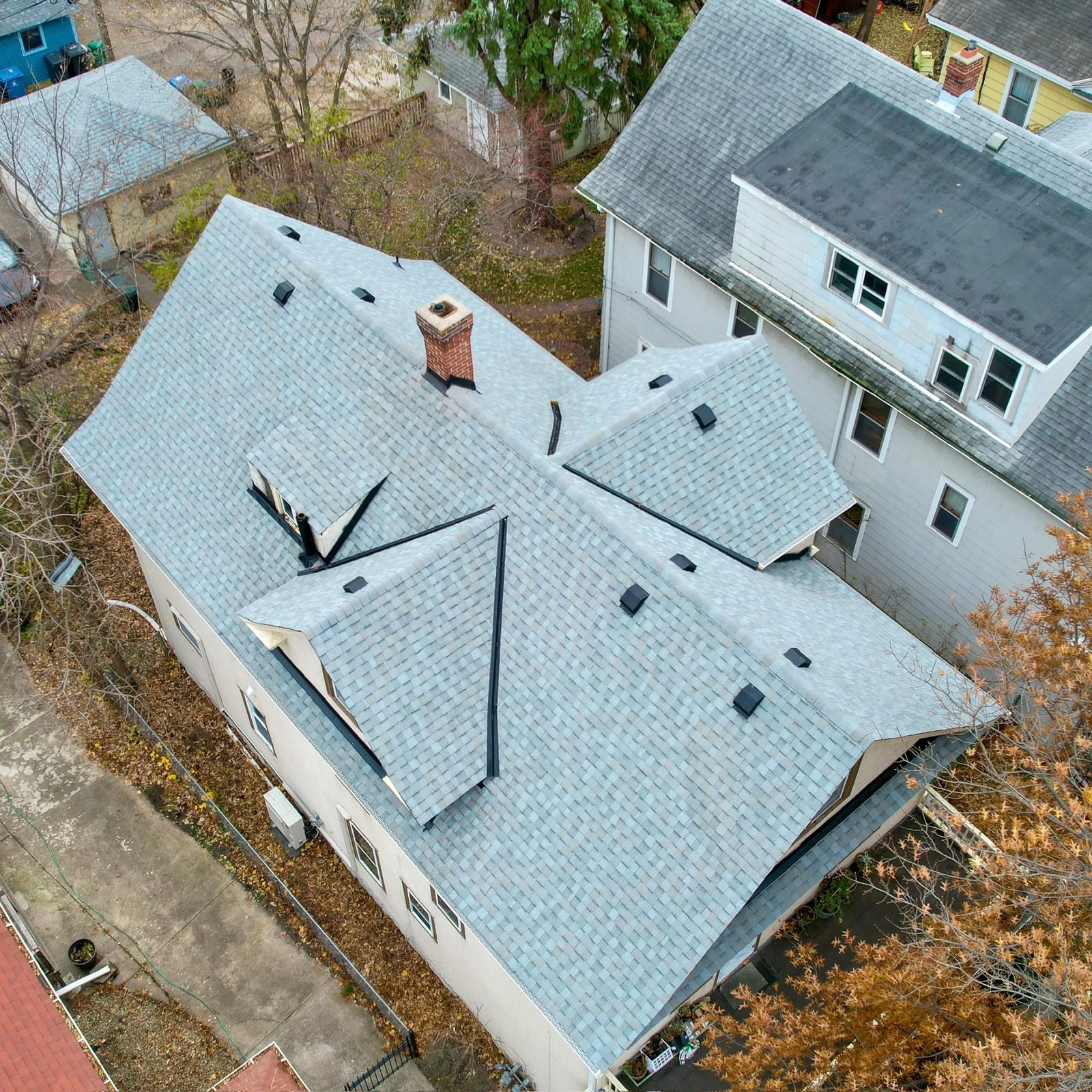 New light gray shingle roof on an older two-story home