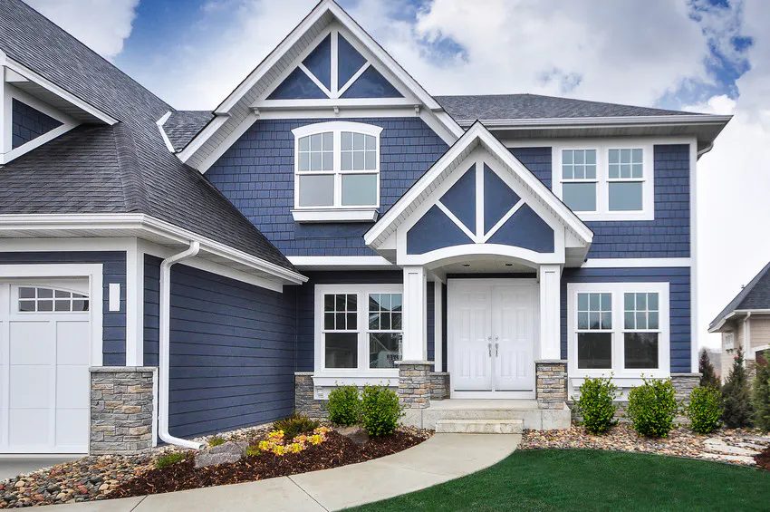 Navy shake siding with white trim on a craftsman home