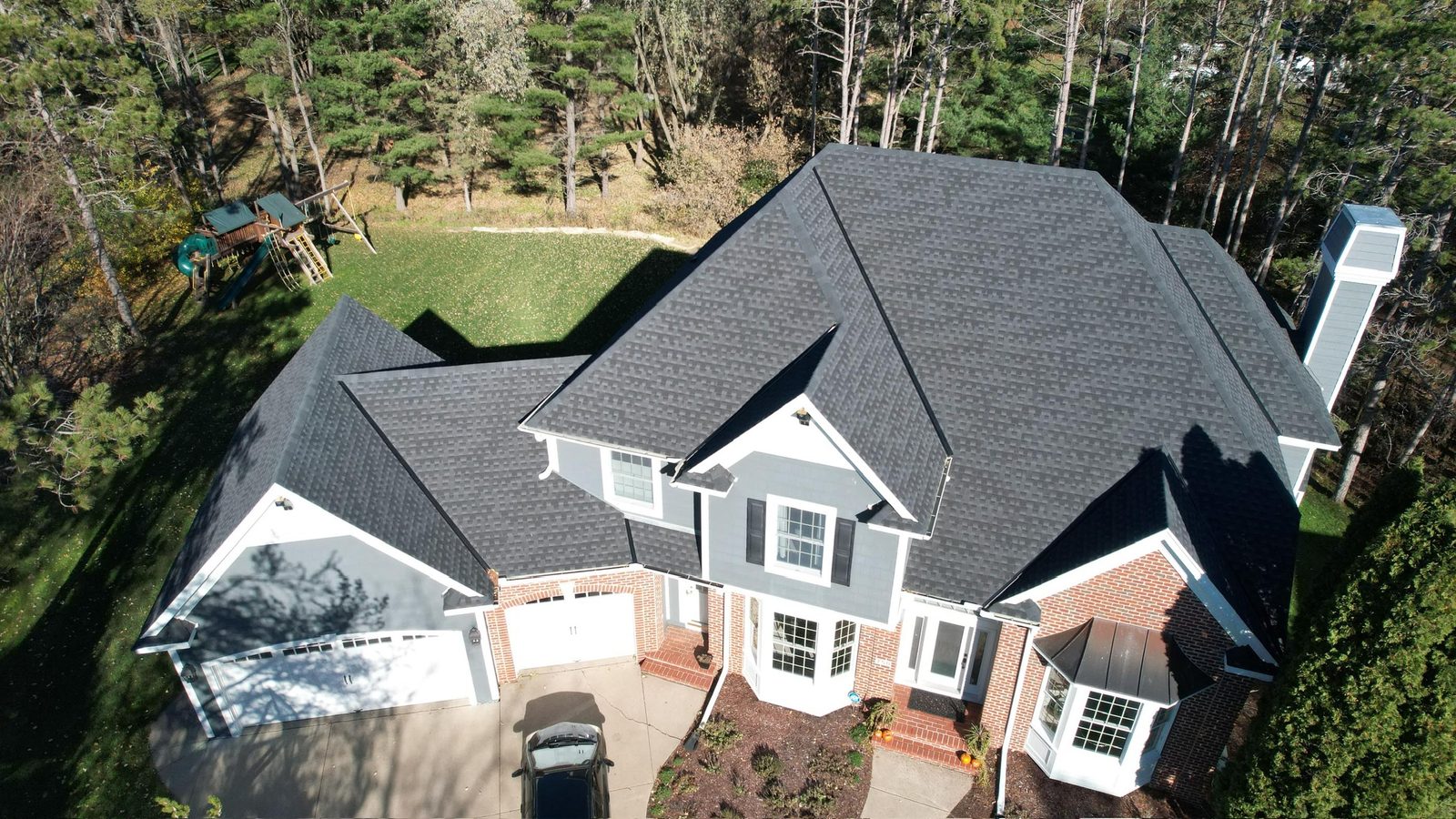 New charcoal shingle roof on a two-story home