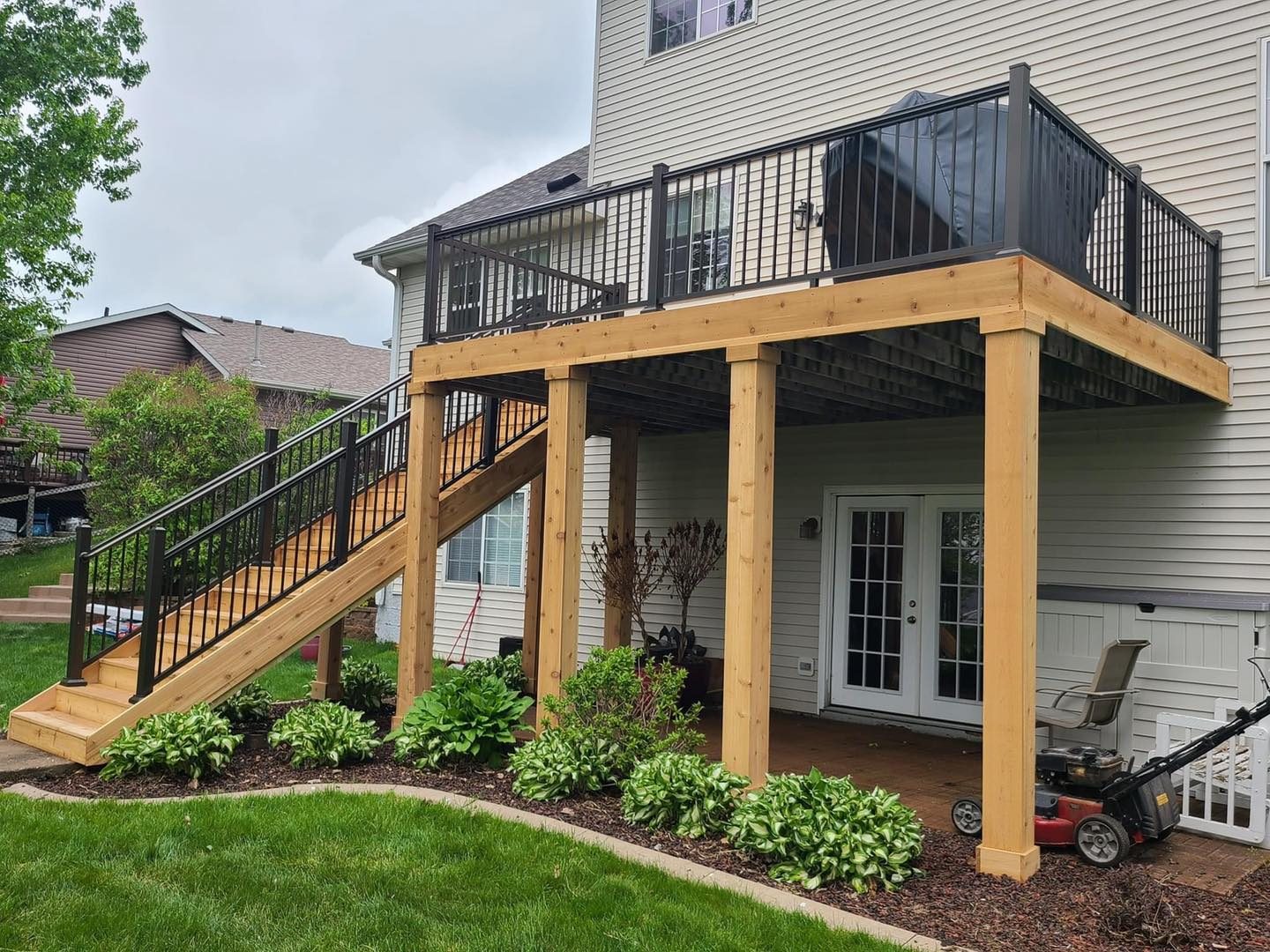 Two-story deck with cedar posts and black railing