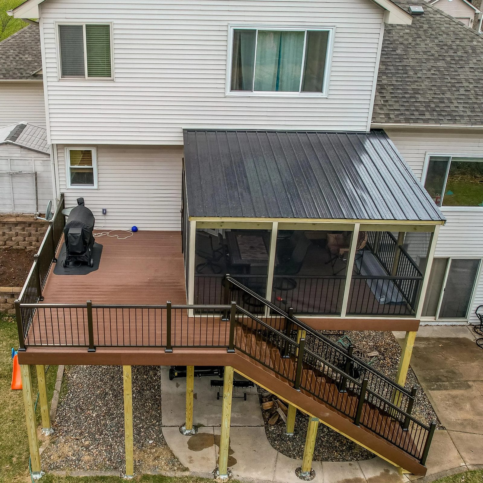 Screened porch and composite deck on the back of a two-story home
