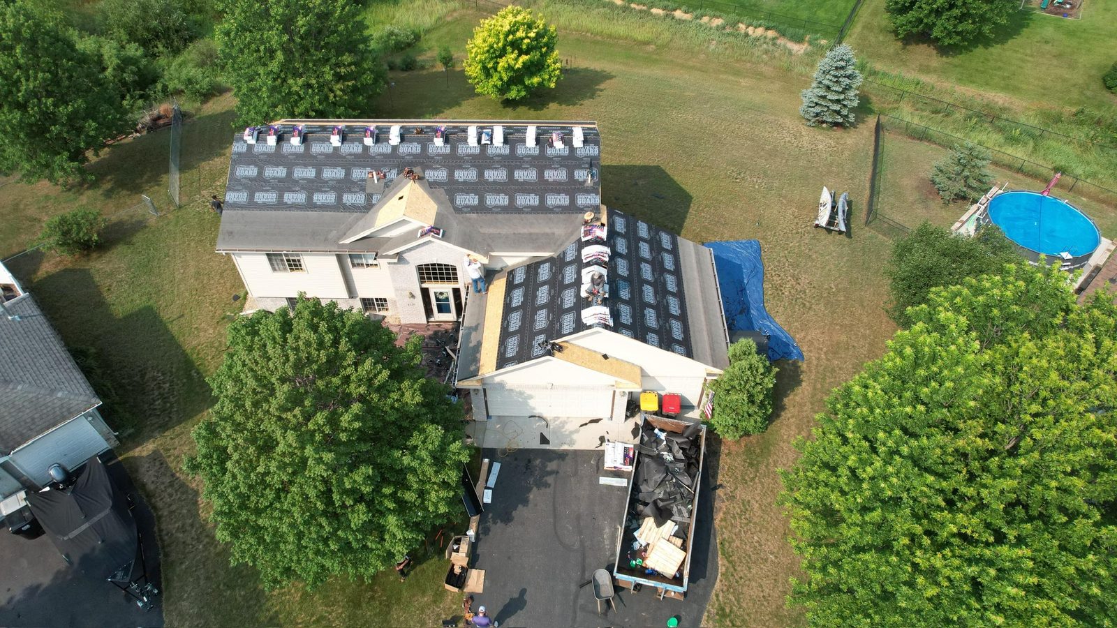 Roof replacement in progress on a rural home