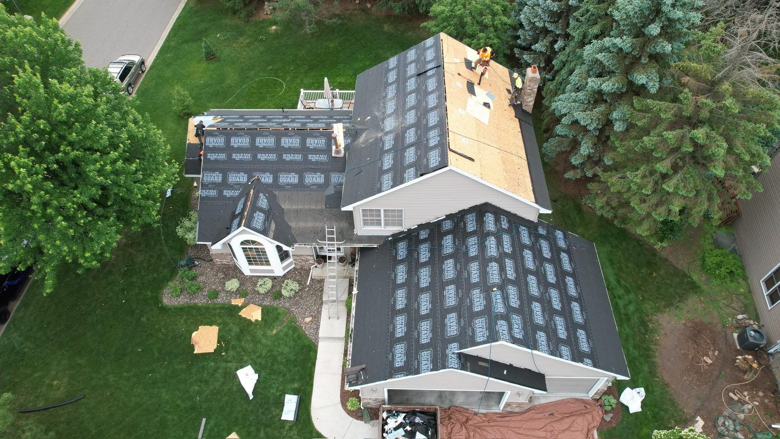 Roof replacement in progress with new underlayment